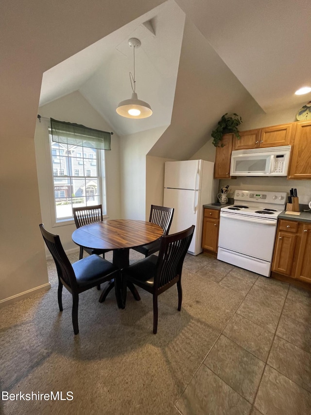 dining area featuring vaulted ceiling and light tile patterned floors