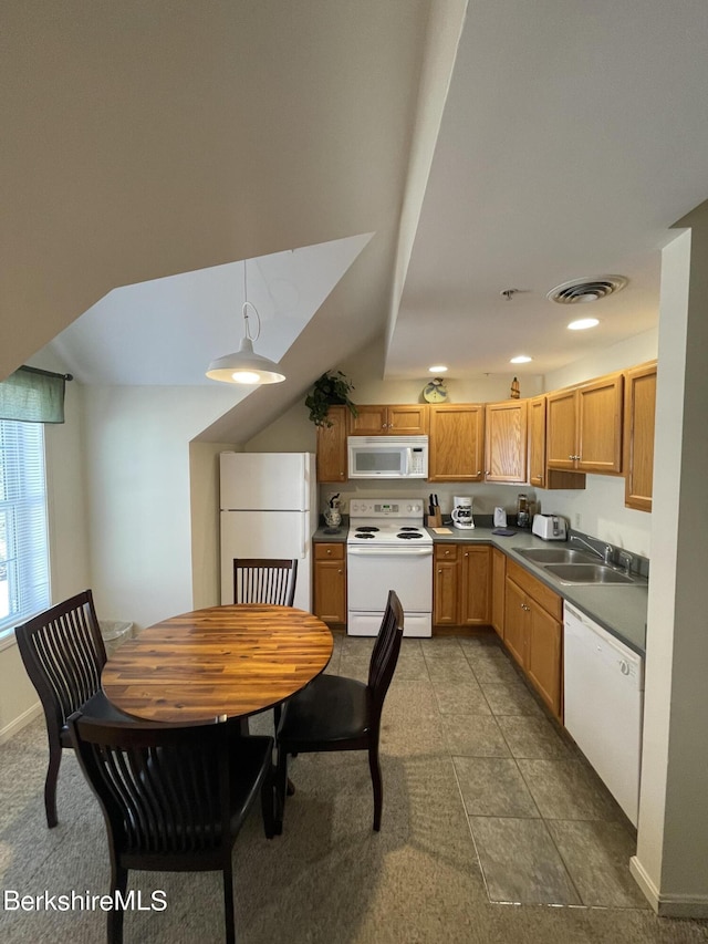 kitchen featuring tile patterned flooring, sink, white appliances, and decorative light fixtures