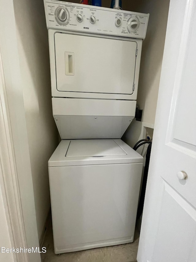 laundry room with stacked washer / dryer