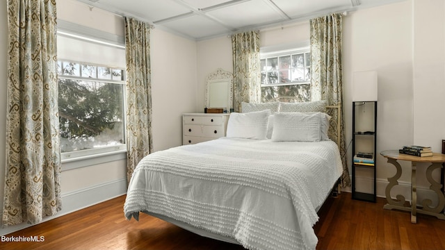 bedroom featuring wood finished floors and baseboards