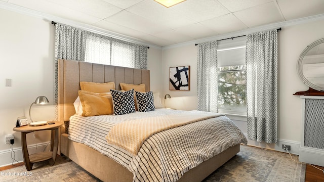 bedroom with baseboards, multiple windows, and crown molding