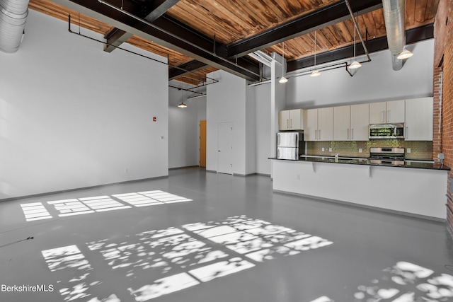 garage with stainless steel refrigerator and sink