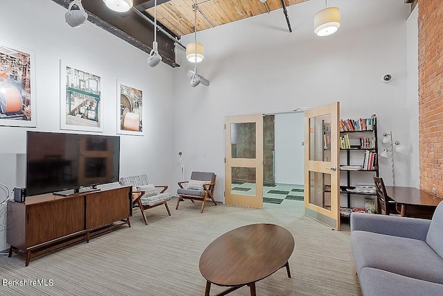 living room featuring a towering ceiling and french doors