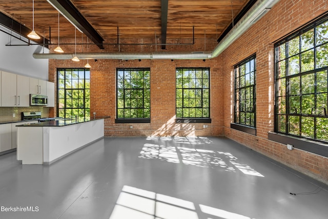 unfurnished sunroom with beamed ceiling and wooden ceiling