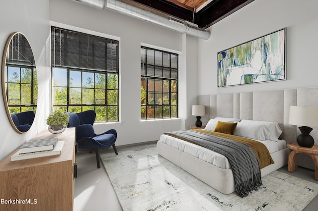 bedroom featuring concrete flooring