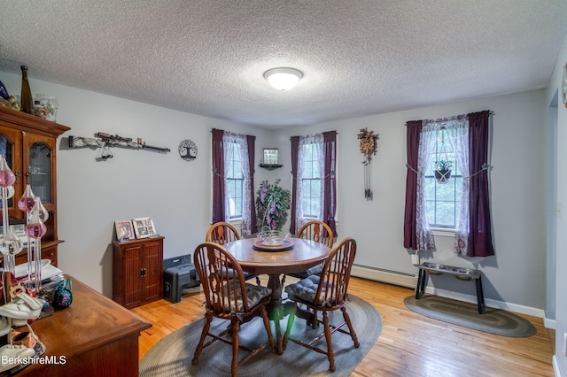 495 Williamstown Rd, Lanesborough, MA 01237 - dining room featuring a textured ceiling, light wood finished floors, and a baseboard heating unit