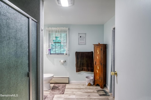 495 Williamstown Rd, Lanesborough, MA 01237 - bathroom with a baseboard radiator, toilet, wood finished floors, a stall shower, and baseboards
