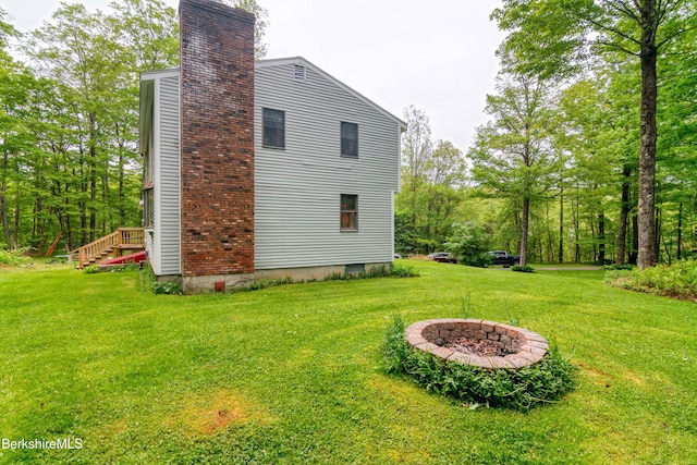495 Williamstown Rd, Lanesborough, MA 01237 - view of home's exterior featuring a chimney, a lawn, and an outdoor fire pit