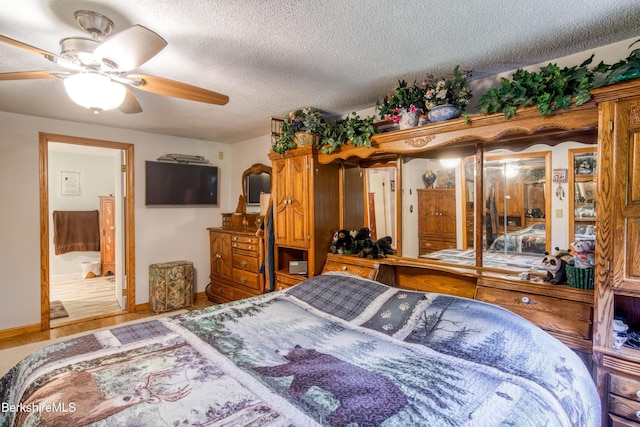 495 Williamstown Rd, Lanesborough, MA 01237 - bedroom with a textured ceiling, baseboards, wood finished floors, and ensuite bath