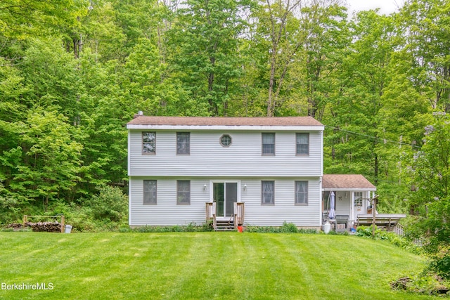 495 Williamstown Rd, Lanesborough, MA 01237 - colonial home featuring a front lawn, a forest view, and a chimney