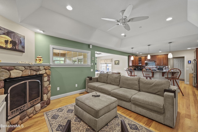 200 Easthampton Rd, Westhampton, MA 01027 - living area with a raised ceiling, recessed lighting, ceiling fan, a fireplace, and light wood finished floors
