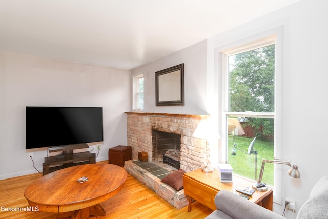 63 Yarmouth St, Pittsfield, MA 01201 - living area with a fireplace with raised hearth and wood finished floors