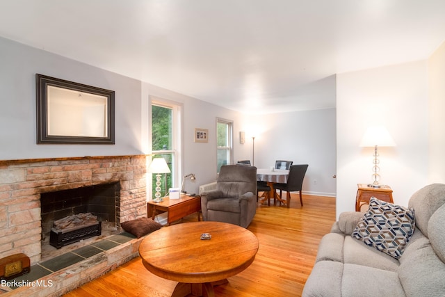 63 Yarmouth St, Pittsfield, MA 01201 - living room featuring wood finished floors and a fireplace with raised hearth