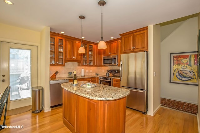 770 Summer St Unit 5D, Lee, MA 01238 - kitchen featuring stainless steel appliances, light wood finished floors, light stone counters, brown cabinets, and recessed lighting