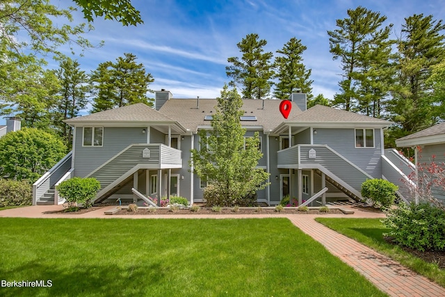 770 Summer St Unit 5D, Lee, MA 01238 - rear view of house with stairs, a yard, and a chimney