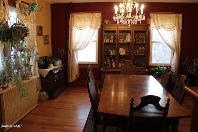 dining area featuring a chandelier and hardwood / wood-style floors