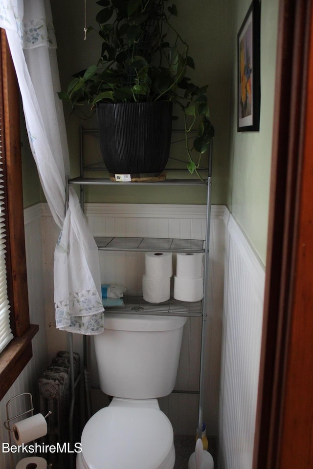 bathroom featuring toilet and radiator heating unit