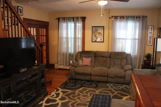 living room with ceiling fan, wood-type flooring, and a baseboard radiator