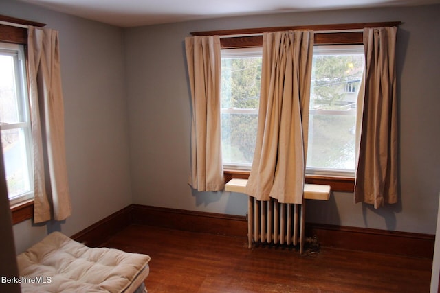 interior space featuring radiator and hardwood / wood-style flooring