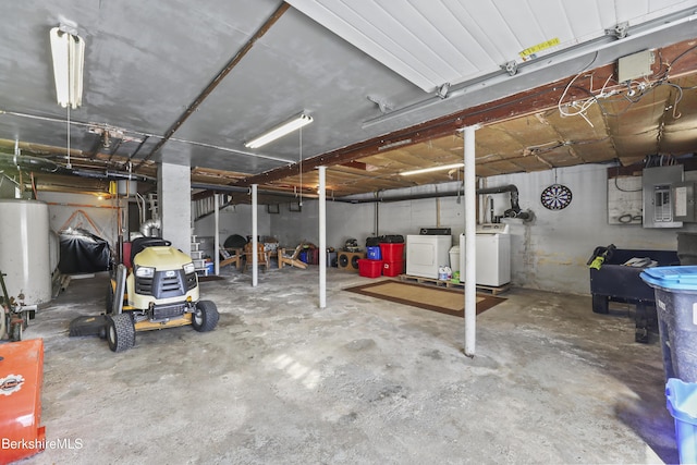 garage with washer and dryer, electric panel, and water heater