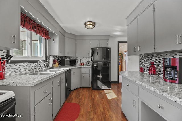 kitchen featuring black appliances, a sink, and gray cabinetry