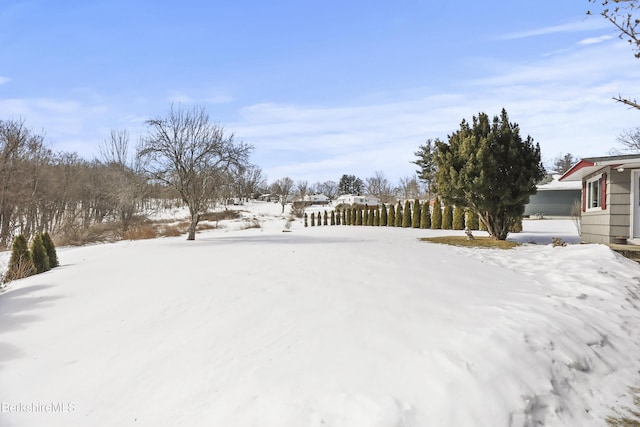 snowy yard featuring fence