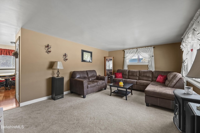 living room with light carpet and baseboards