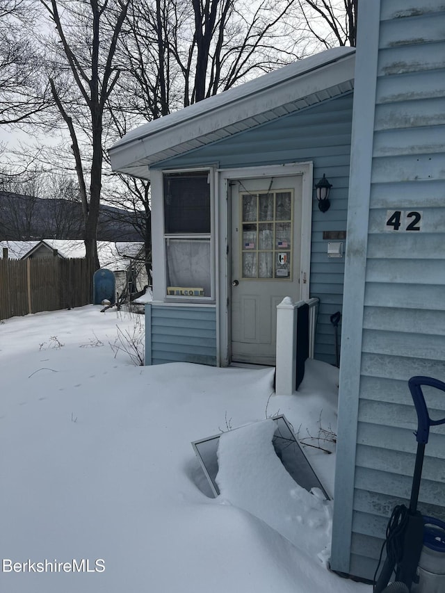 view of snow covered property entrance