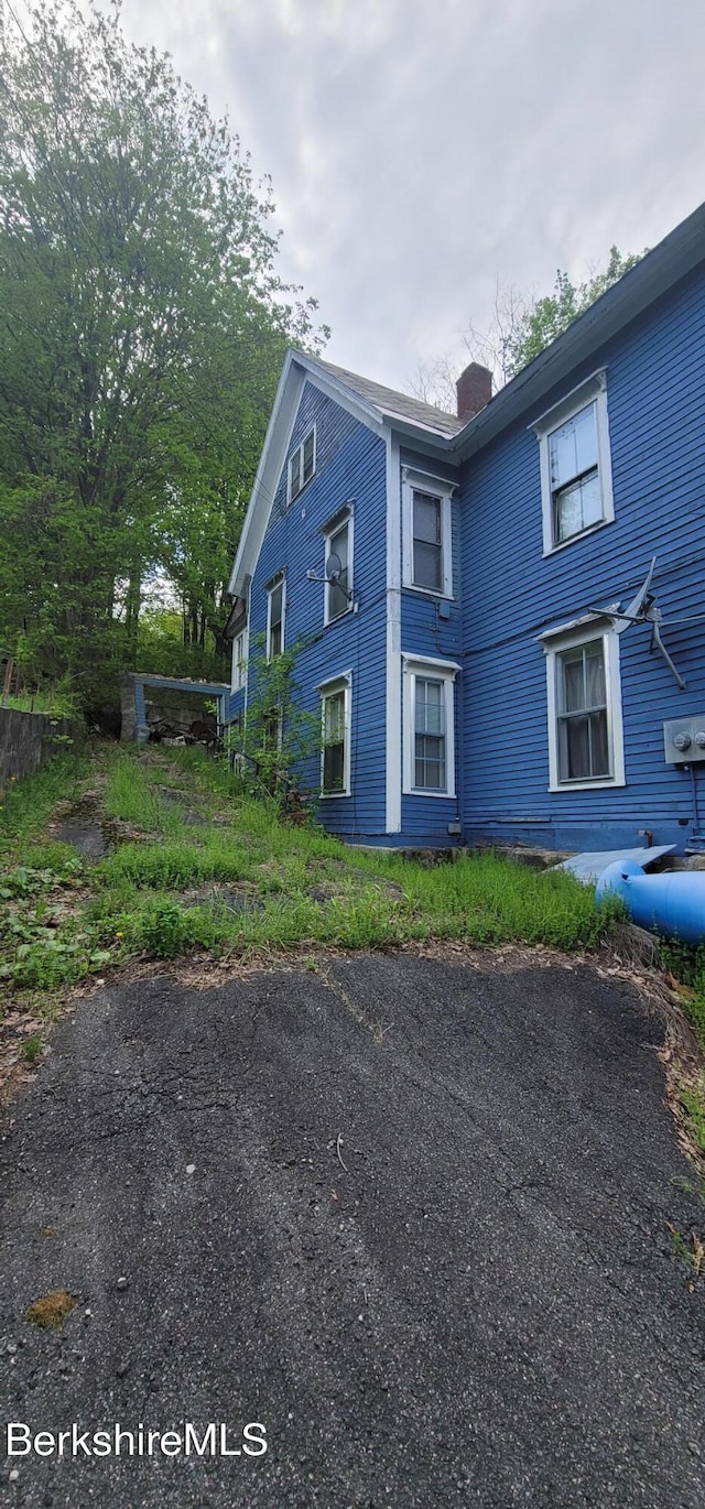 301 Walnut St, North Adams, MA 01247 - view of side of home featuring a chimney