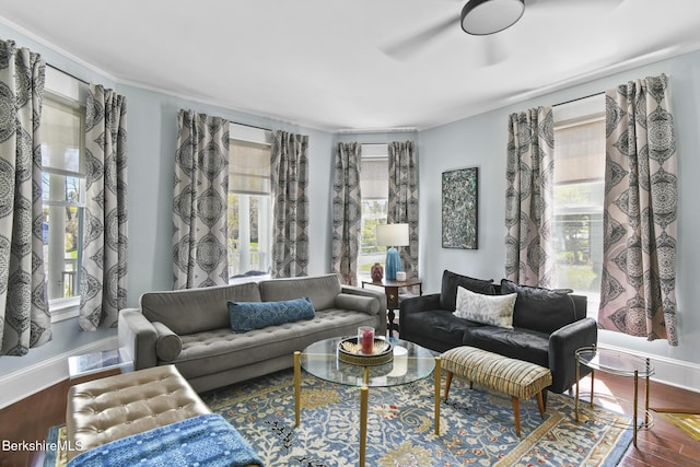 living room with baseboards, ceiling fan, wood finished floors, and a wealth of natural light