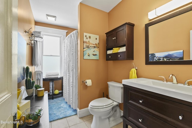 bathroom with tile patterned floors, vanity, toilet, and visible vents