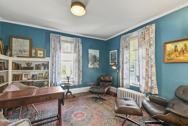 sitting room with crown molding, a healthy amount of sunlight, radiator heating unit, and wood finished floors