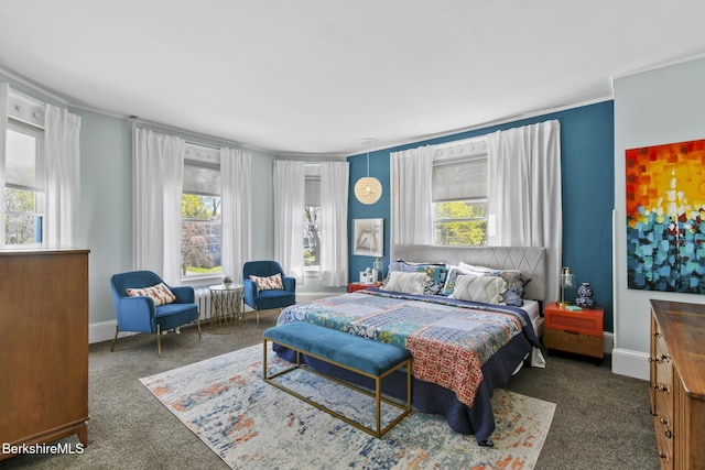bedroom featuring dark carpet, ornamental molding, and baseboards