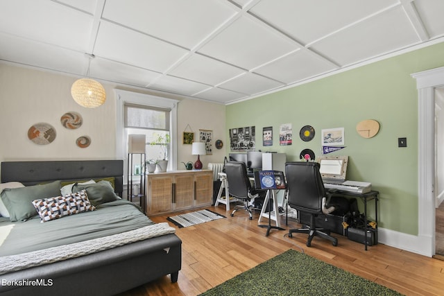 bedroom featuring baseboards and wood finished floors
