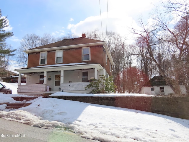 view of front of house with covered porch and a chimney