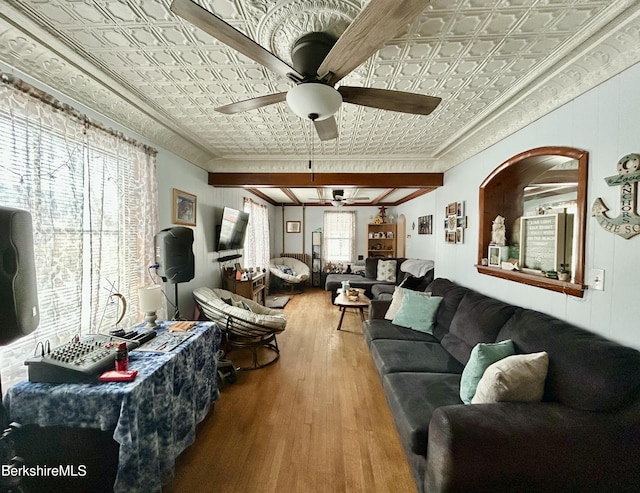 living room with crown molding, wood finished floors, an ornate ceiling, and ceiling fan