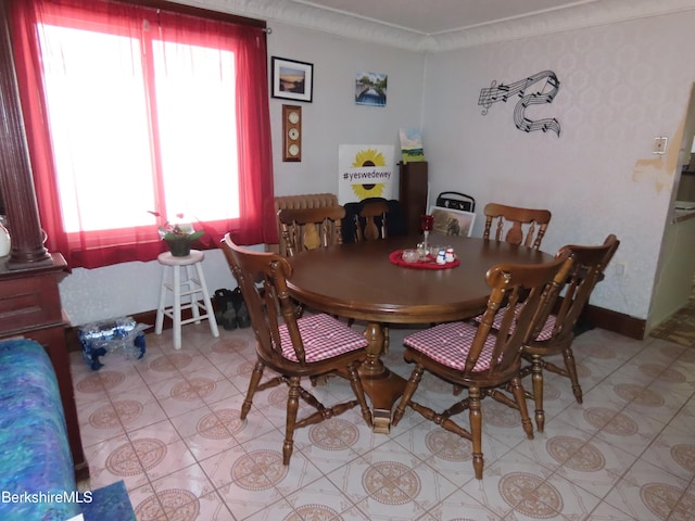 dining room with crown molding and baseboards