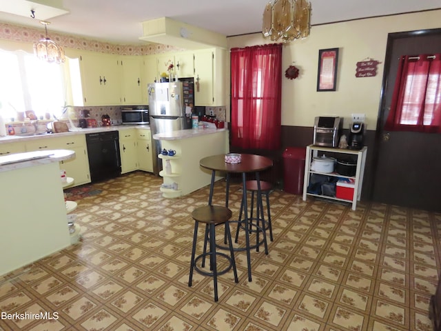 kitchen with a chandelier, light floors, stainless steel appliances, and light countertops