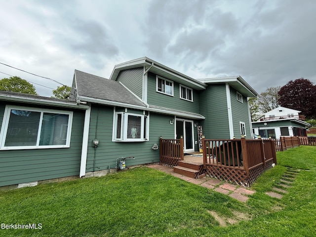 back of house with a deck