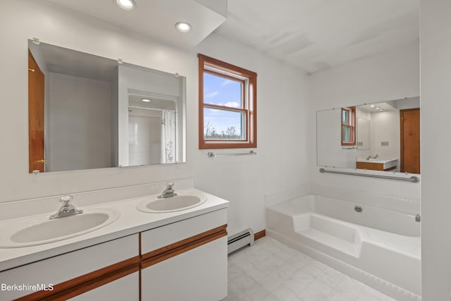 full bath featuring baseboard heating, baseboards, a garden tub, double vanity, and recessed lighting