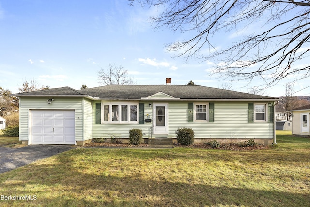 single story home with a front yard and a garage