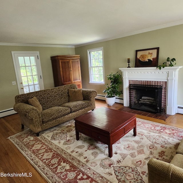 377 Pomeroy Ave, Pittsfield, MA 01201 - living room featuring crown molding, a brick fireplace, wood finished floors, and a baseboard radiator