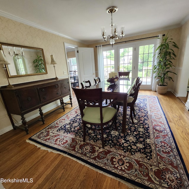 377 Pomeroy Ave, Pittsfield, MA 01201 - dining space featuring a chandelier, crown molding, light wood-type flooring, and wallpapered walls