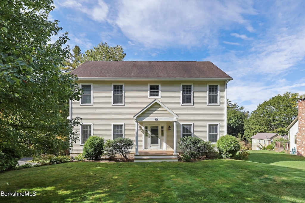 colonial home with a front lawn