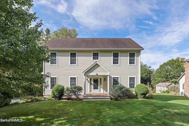 colonial home with a front lawn