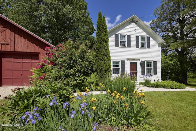 220 N Plain Rd, Great Barrington, MA 01230 - view of front of house with a front yard, board and batten siding, and a garage