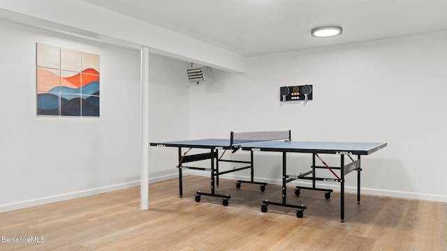 recreation room with baseboards and wood finished floors