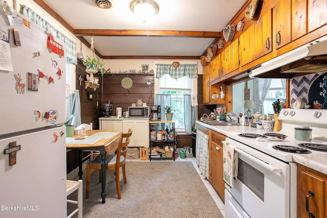53 Mahaiwe St, Great Barrington, MA 01230 - kitchen featuring white appliances, brown cabinets, light countertops, under cabinet range hood, and beamed ceiling