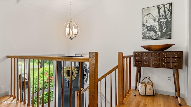 22 Delafield Dr, Lenox, MA 01240 - staircase with wood finished floors, a chandelier, and lofted ceiling