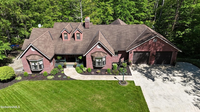 5 Victoria Ln, Lanesborough, MA 01237 - view of front facade with an attached garage, driveway, a front yard, a chimney, and brick siding